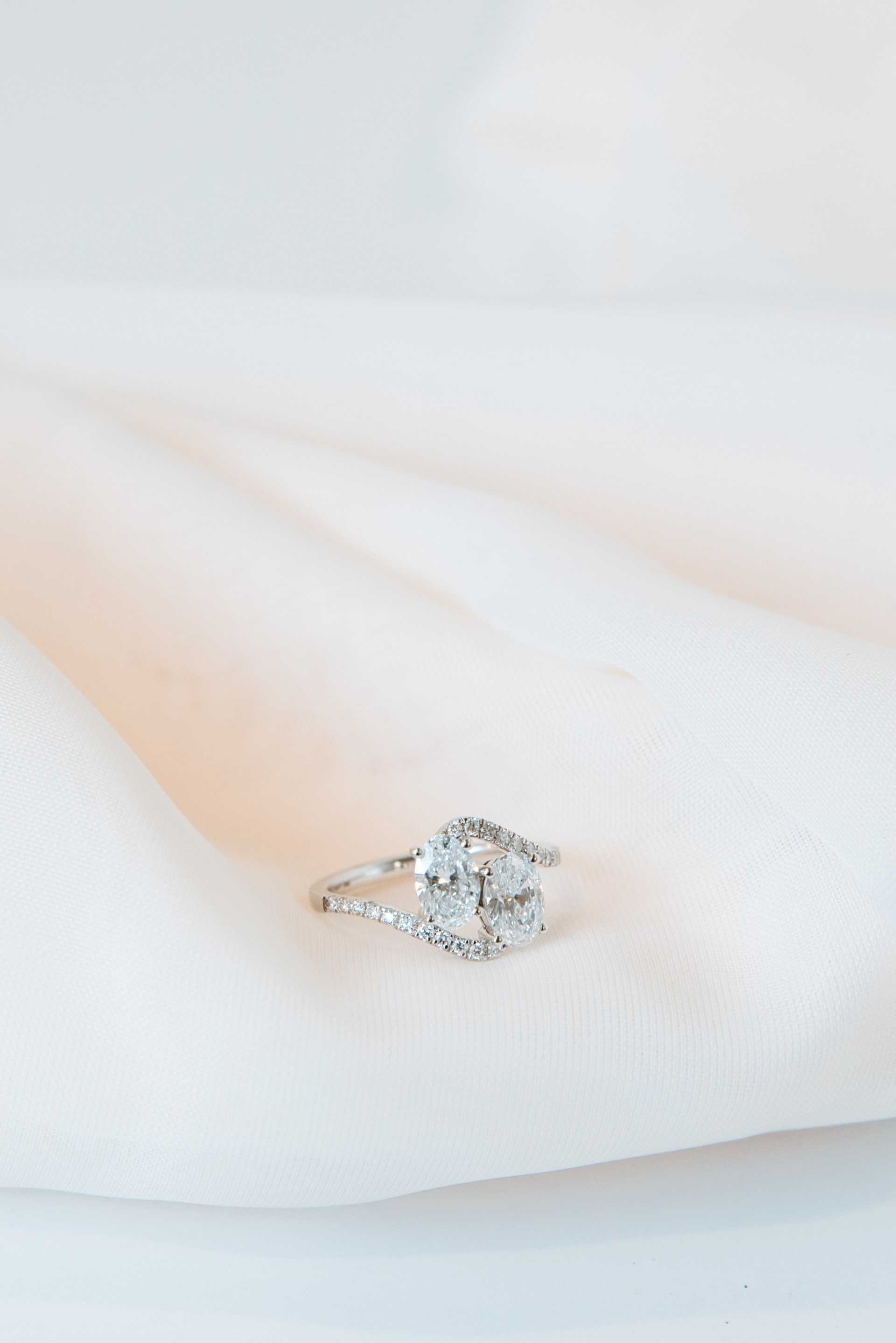 Solitaire diamond ring on white silk