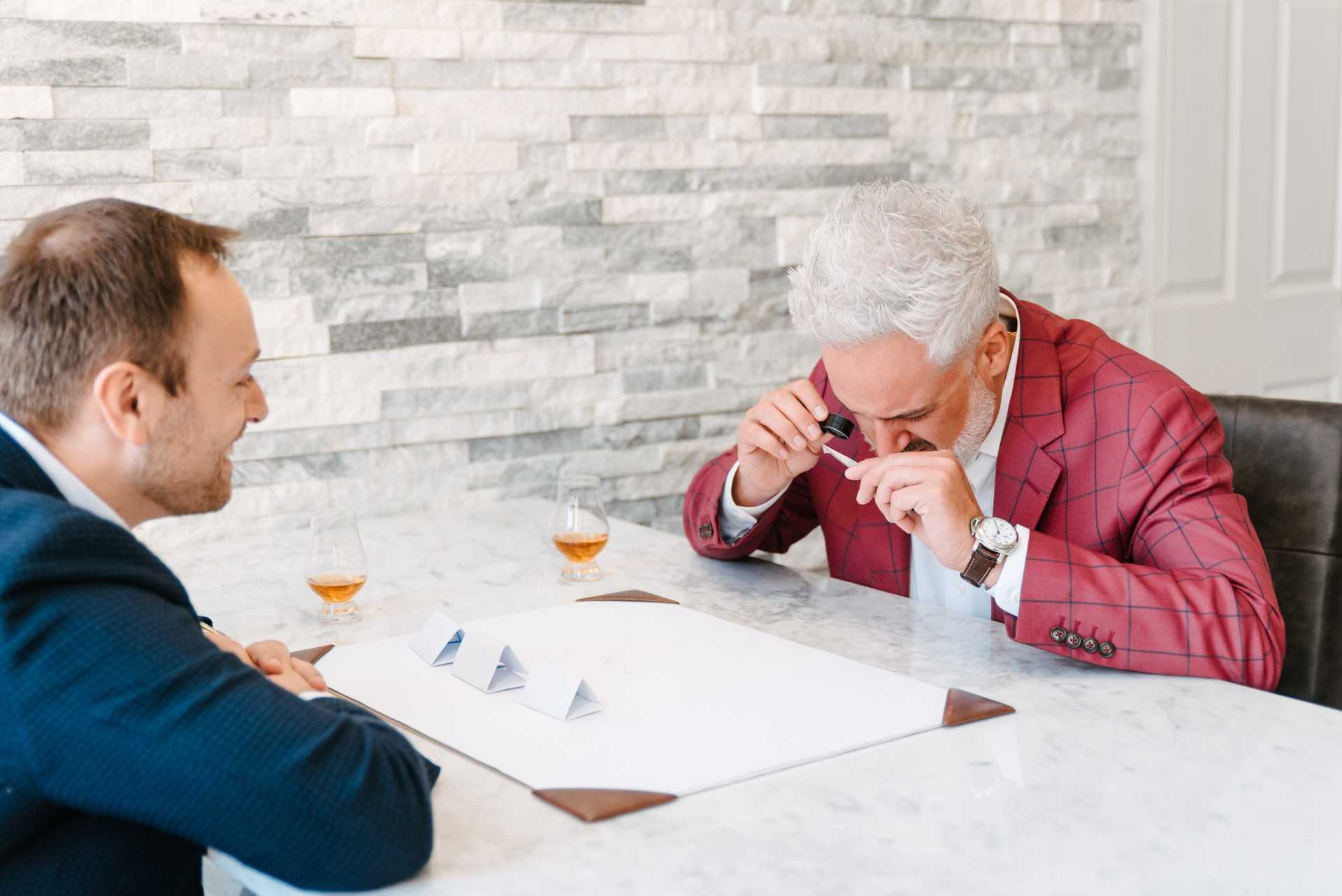 Examining a stone under a loupe