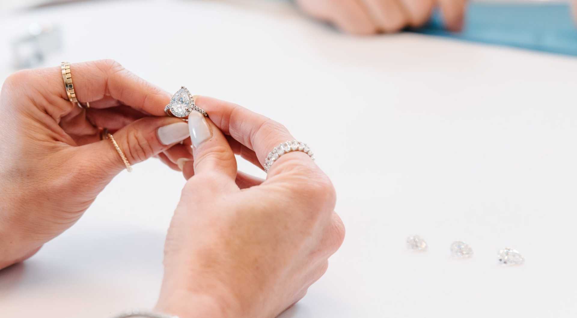 Hands holding a diamond engagement ring